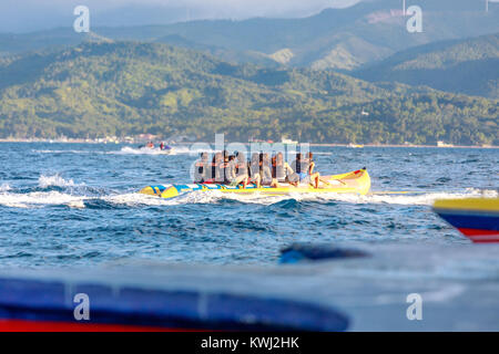 BORACAY ISLAND, PHILIPPINES - November 18, 2017 : Tourists ride a Banana Boat on Boracay sea Stock Photo