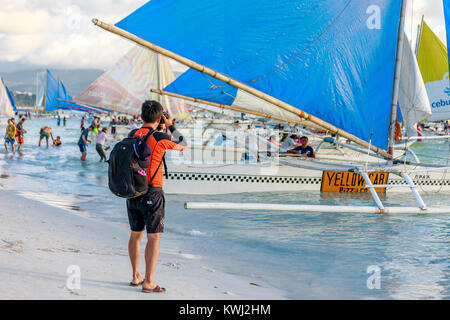 BORACAY ISLAND, PHILIPPINES - November 18, 2017 : Tourist waiting a boat to leave the tour on Crowded Boracay beach Stock Photo