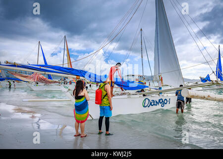 BORACAY ISLAND, PHILIPPINES - November 18, 2017 : Tourists waiting a boat to leave the tour on Crowded Boracay beach Stock Photo