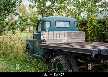 rusty old abandoned vintage pickup truck in field Stock Photo