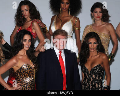 NEW YORK, NY - JULY 27: Donald Trump and Miss Universe Organization President Paula Shugart (C) and (L-R) Miss Tanzania 2007 Flaviana Matata, Miss Albania 2010 Angela Martini, Miss Ireland 2010 Rosanna Purcell, Miss USA 2003 Susie Castillo, Miss USA 2004 Shandi Finnessey, Miss Universe 2003 Amelia Vega, Miss Universe 2008 Dayanna Mendoza, Miss Universe 2002 Justine Pasek, Miss Universe 2007 Riyo Mori, Miss Kosovo 2009 Marigona Dragusha, Miss Kosovo 2008 Zana Krasniqi, and Miss France 2009 Chloe Mortaud attend a photocall at Chelsea Piers, Studio 59 on July 27, 2011 in New York City.  People:   Stock Photo