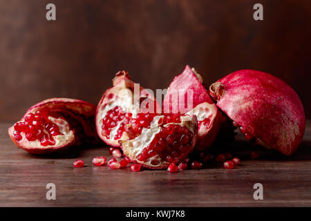 Ripe pomegranate on a old wooden table. Stock Photo