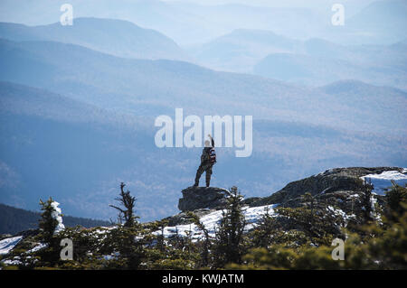 Lone hiker takes in the view south from Mt. Mansfield, highest point in Vermont, USA, New England, Stowe, VT, Green Mountains. Stock Photo