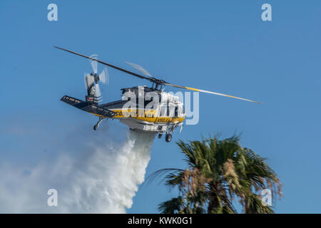 Los Angeles County Fire Department Air 16 doing a water drop on a brush fire. Stock Photo