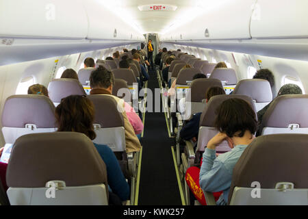 The cabin aisle on a Embraer 190 passenger plane ...