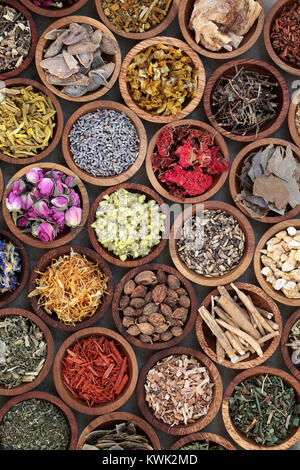 Natural herbal medicine selection with a variety of dried herbs and flowers in wooden bowls. Top view. Stock Photo