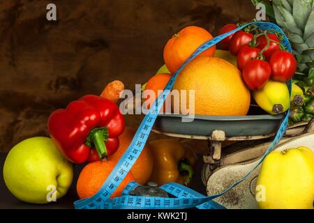 Old cast iron kitchen scale with fruit and vegetables. Healthy eating. Selling fruit Stock Photo