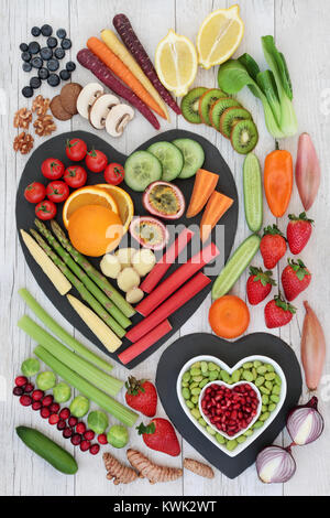 Super food for healthy life concept with fresh vegetables, fruit, nuts and spices with foods high in  anthocyanins and antioxidants, omega 3. Stock Photo