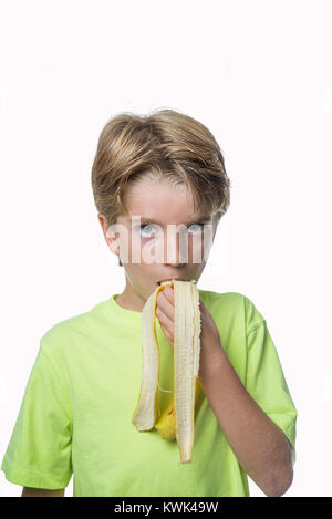 Portrait of a boy eating banana Stock Photo