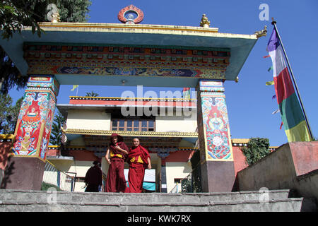 Two monks and gate of Shechen monastery in Kathmandu, Nepal Stock Photo