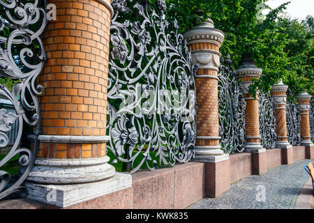 Mikhailovsky garden, bordered by brick columns with old wrought iron fences in Art Nouveau style, Saint Petersburg, Russia. Stock Photo