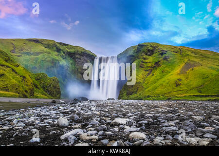 Classic long exposure view of famous Skogafoss waterfall in beautiful twilight during blue hour at dusk in summer, Skogar, south of Iceland Stock Photo