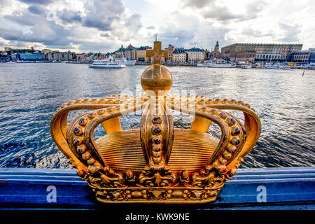 Golden crown on Skeppsholm bridge with Stockholms slot (royal palace) in the background - Stockholm - Sweden - Scandinavia - Europe Stock Photo