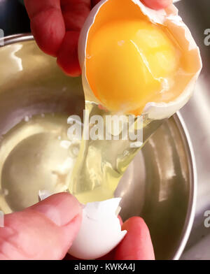 Man Cracking a Raw Egg, USA Stock Photo