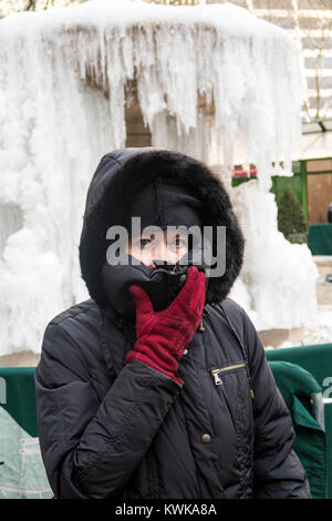 Senior Woman in front of the Frozen Josephine Shaw Lowell Memorial Fountain in Bryant Park, NYC, USA Stock Photo