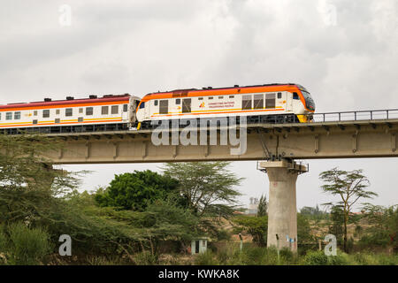 The Madaraka Express Passenger Service train travelling on a viaduct section of the Nairobi to Mombasa Standard Gauge Railway SGR, Kenya Stock Photo