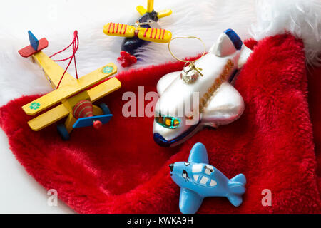 Airplane Christmas Ornaments on Red Santa Hat Stock Photo