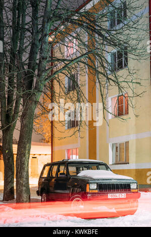 Black Jeep Cherokee Xj Car Parked In Residential Area With Light Trail In Winter Evening. Stock Photo