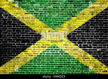 Flag of Jamaica painted on brick wall, background texture Stock Photo