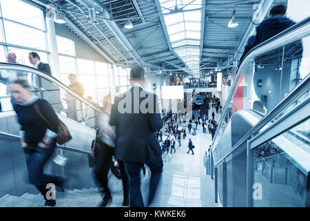 blurred business people walking at a business center entrance. including copy space banner. Stock Photo