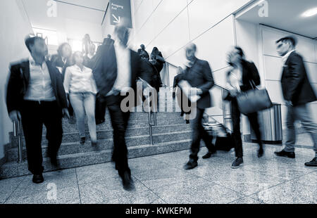 business people rushing on stairs in a modern hall. Stock Photo