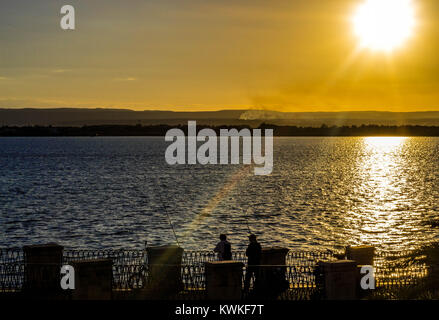 Ortigia's Fishermen having great time under their warm Sicilian sun , Ortigia , Sicily Stock Photo