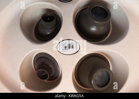 Flight attendant cabin crew call button & cool air nozzles / nozzle array above passenger seat in Embraer aeroplane / airplane / aircraft / air plane Stock Photo