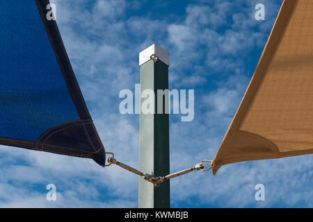 Blue and brown canvas subject to structure with background of clouds and blue sky Stock Photo