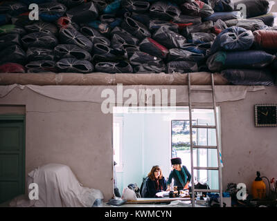 Mytilini, Greece. 8th Feb, 2016. Linda and Katerina, two Dirty Girls at the laundry where the group bring all the clothes to be washed and dried.Dirty Girls of Lesbos is a volunteer group born in September 2015 by the idea of Alison Terry-Evans.The volunteer group is almost only women group who takes care of sorting out, washing, and make ready to be reused, the clothes of the hundreds of thousand of migrants who passed through the island. The idea is that instead of buying new clothes or waiting for donations, wet clothes of migrants arriving with boats, are exchanged with clean ones Stock Photo