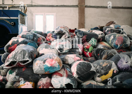 Mytilini, Greece. 8th Feb, 2016. Clean piled clothes ready to be re-used.Dirty Girls of Lesbos is a volunteer group born in September 2015 by the idea of Alison Terry-Evans.The volunteer group is almost only women group who takes care of sorting out, washing, and make ready to be reused, the clothes of the hundreds of thousand of migrants who passed through the island. The idea is that instead of buying new clothes or waiting for donations, wet clothes of migrants arriving with boats, are exchanged with clean ones who belonged to other migrants who passed thought the island earlier. (C Stock Photo