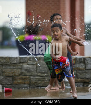 Rock Island, Iowa, USA. 2nd July, 2017. CorDae Lankford, 5, of Rock Island runs from Isiah Westerfield, 9, of Rock Island as he is splashed with water at Schwiebert Park in Rock Island on Sunday, July 2, 2017. Credit: Andy Abeyta, Quad-City Times/Quad-City Times/ZUMA Wire/Alamy Live News Stock Photo