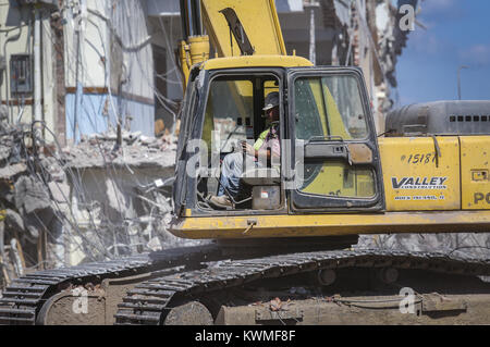 Davenport, Iowa, USA. 8th Aug, 2017. Equipment operator Brian Pomiller of Valley Construction works the controls of his excavator while demolishing Sacred Heart school in Davenport on Tuesday, August 8, 2017. The 100-year-old school at Sacred Heart Cathedral is being demolished as a new diocesan center addition to the cathedral is in progress. The school's location will be used as a parking lot. Credit: Andy Abeyta, Quad-City Times/Quad-City Times/ZUMA Wire/Alamy Live News Stock Photo