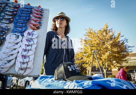 Davenport, Iowa, USA. 13th Oct, 2016. Ashley Moore of Tampa, Florida works her stand of Hillary Clinton gear out front of North High School while a crowd awaits the arrival of Former President Bill Clinton .during a bus tour stop in Davenport on Thursday, October 13, 2016. The Former President spoke on behalf of wife Hillary Clinton on her campaign for office and encouraged Iowans to get out and vote. Credit: Andy Abeyta/Quad-City Times/ZUMA Wire/Alamy Live News Stock Photo