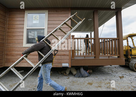 Davenport, Iowa, USA. 30th Nov, 2016. A crew with Design Homes Inc. gets the first half of a cabin ready to be lifted onto its foundation at West Lake Park in Davenport on Wednesday, November 30, 2016. West Lake Park welcomes two new pre-constructed cabins to be set on a plot of land overlooking Railroad Lake. Credit: Andy Abeyta/Quad-City Times/ZUMA Wire/Alamy Live News Stock Photo