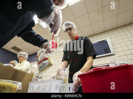 Bettendorf, Iowa, USA. 8th Dec, 2016. First year culinary student Tyler Jordan, right, weighs meal bags with second year culinary student Jose Solero, left, at Scott Community College in Bettendorf on Thursday, December 8, 2016. Faculty, staff, and students worked together in partnership with The Outreach Program to package meals for families to be distributed in the Quad-City area. Credit: Andy Abeyta/Quad-City Times/ZUMA Wire/Ģ����ý Live News Stock Photo