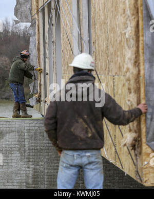 Davenport, Iowa, USA. 30th Nov, 2016. Men work to line up the first half of the cabin with its foundation at West Lake Park in Davenport on Wednesday, November 30, 2016. West Lake Park welcomes two new pre-constructed cabins to be set on a plot of land overlooking Railroad Lake. Credit: Andy Abeyta/Quad-City Times/ZUMA Wire/Alamy Live News Stock Photo