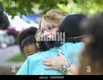 Davenport, Iowa, USA. 25th June, 2017. Susan Poe of Cape Girardeau, Missouri gives hugs while talking about her son Derek James Jackson, who was murdered in December of 2013, before starting the march at Vander Veer Botanical Park in Davenport on Sunday, June 25, 2017. Nearly 200 people attended the second annual Walk/Run Against Gun Violence in Memory of Dwight McCall Jr., a Rock Island native who was killed in Peoria five years ago. Families and friends celebrated the lives of local loved ones who were killed in result of gun violence. (Credit Image: © Andy Abeyta, Quad-City Times/Quad-City Stock Photo