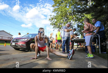 Davenport, Iowa, USA. 13th July, 2017. Liz Nolte of Davenport stretches out before the Bix at Six training run in Davenport on Thursday, July 13, 2017. The run marks the third and final training run leading up to the Quad-City Times Bix 7 Race on Saturday, July 29. Credit: Andy Abeyta, Quad-City Times/Quad-City Times/ZUMA Wire/Alamy Live News Stock Photo