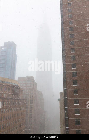 New York City, USA. 4th January, 2018. The iconic Empire State Building is barely visible through the swirling snow. Credit: Patti McConville/Alamy Live News Stock Photo