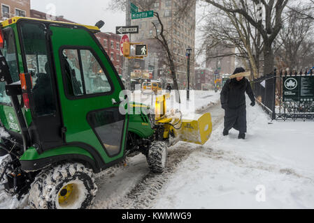 New York, USA. 4th Jan, 2018. New Yorkers trudge through the first snowstorm of  2018. The New York City Parks Department using a sub compact utility vehicle to clear the snow from the sidewalk on Sixth Avenue near Minetta Street. The unusual storm, called a 'Bomb Cyclone' covered the eastern part of the US, from Florida to the Northeast and intensified Wednesday. It is expected to be one of he strongest storms in US history. CREDIT: ©Stacy Walsh Rosenstock/Alamy Live News Stock Photo