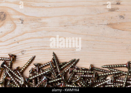 Collection of woodworking, DIY, home improvement screws on a wood background Stock Photo