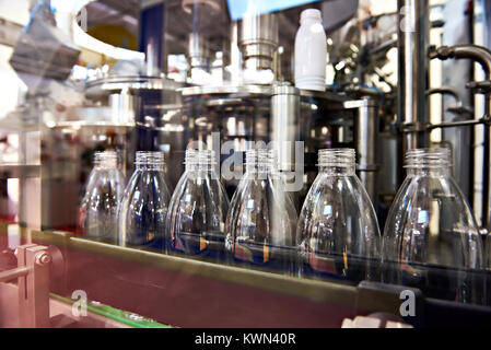 Line of bottling beverages in plastic bottles on factory Stock Photo