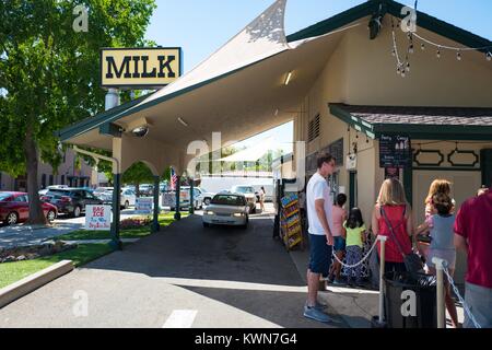 Cars and people wait in line at Meadowlark Dairy, a classic drive-up dairy bar, originally opened in 1969, with signage reading 'Milk', in downtown Pleasanton, California, July 18, 2017. Stock Photo