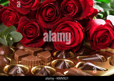 Vibrant red roses on a box of chocolates for valentine's day, or any day to say I love you. Stock Photo