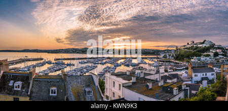 Torquay, Devon, England. August 2017 - Panoramic view of the harbor of the popular seaside resort town during a colorful sunset. Stock Photo