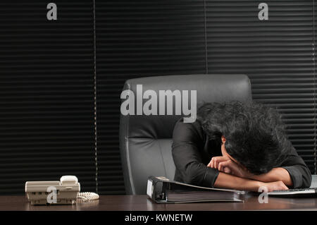 Exhausted business woman inside office Stock Photo