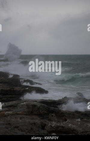 Waves breaking on the shore of the Mediterranean sea in winter Stock Photo