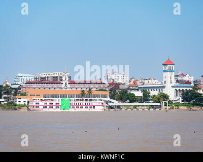 Yangon waterfront as seen across the Yangon River from Dala. The photo shows the Pansodan Ferry Terminal with a passenger ferry going to Dala and Myan Stock Photo