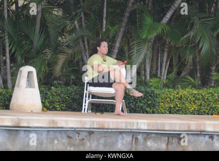 MIAMI BEACH, FL - JUNE 11:  (EXCLUSIVE COVERAGE) Rosie O'Donnell (wearing no make up and a bandage on her foot.)  Enjoys her day as she sits on her dock texting from her estate in Miami. Roseann 'Rosie' O'Donnell (born March 21, 1962) is an American stand-up comedienne, actress, singer, author and media personality. She has also been a magazine editor and continues to be a celebrity blogger, LGBT rights activist; television producer and collaborative partner in the LGBT family vacation company R Family Vacations.   On June 11, 2011 in Miami Beach, Florida    People:  Rosie O'Donnell Stock Photo