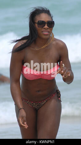 MIAMI BEACH, FL - APRIL 16:  Tennsi great Serena Williams took a break from her rehab efforts with a day at the beach.  The 29-year-old hit Sobe with friends and ate some lunch on the beach before  taking a dip in the ocean wearing a two piece swimsuit with a pink top and leopard print bottom.  on April 16, 2011 in Miami Beach, Florida.   People:  Serena Williams Stock Photo